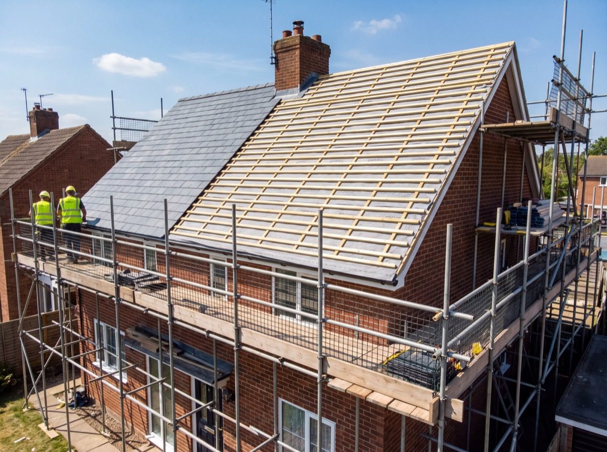 Roof repair project in progress with scaffolding